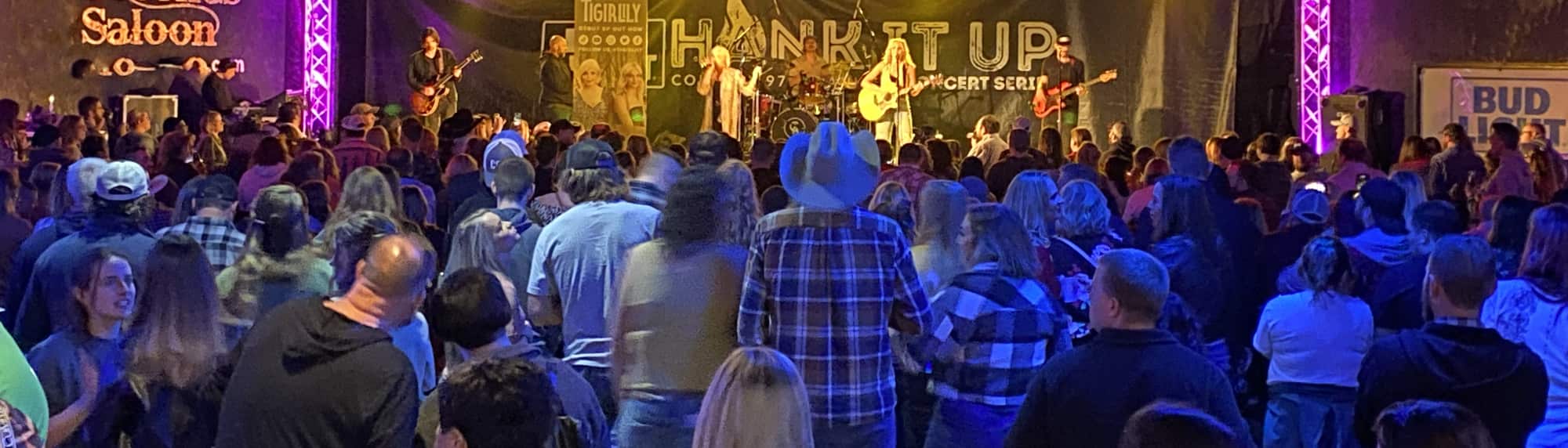 country concert with fans wearing cowboy hats Miami
